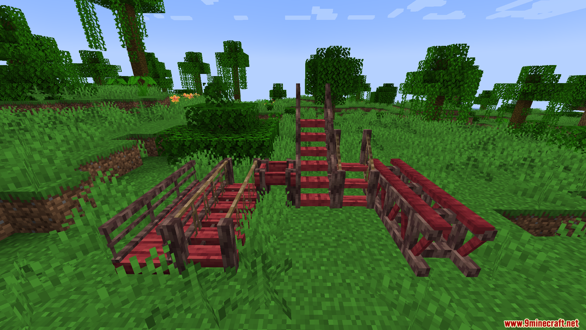 Macaws Regions Unexplored Mod Screenshot 7 Red wooden bridge and stair components placed on grass in a jungle