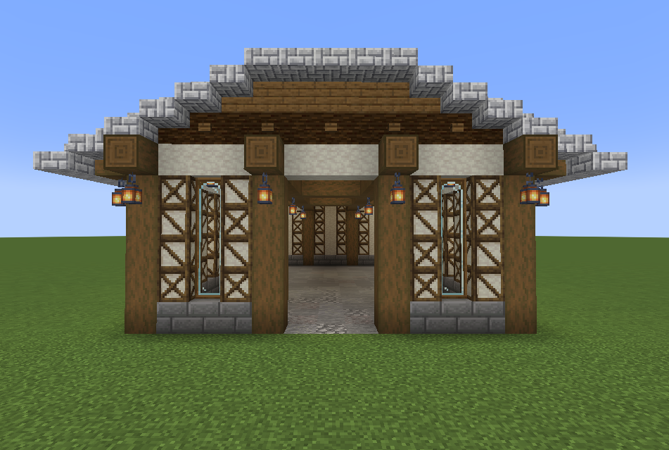 Front view of a detailed Minecraft warehouse build with lanterns and windows