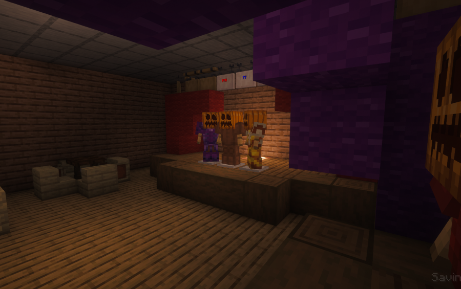 Armor stands with pumpkin heads on a stage with purple wool blocks