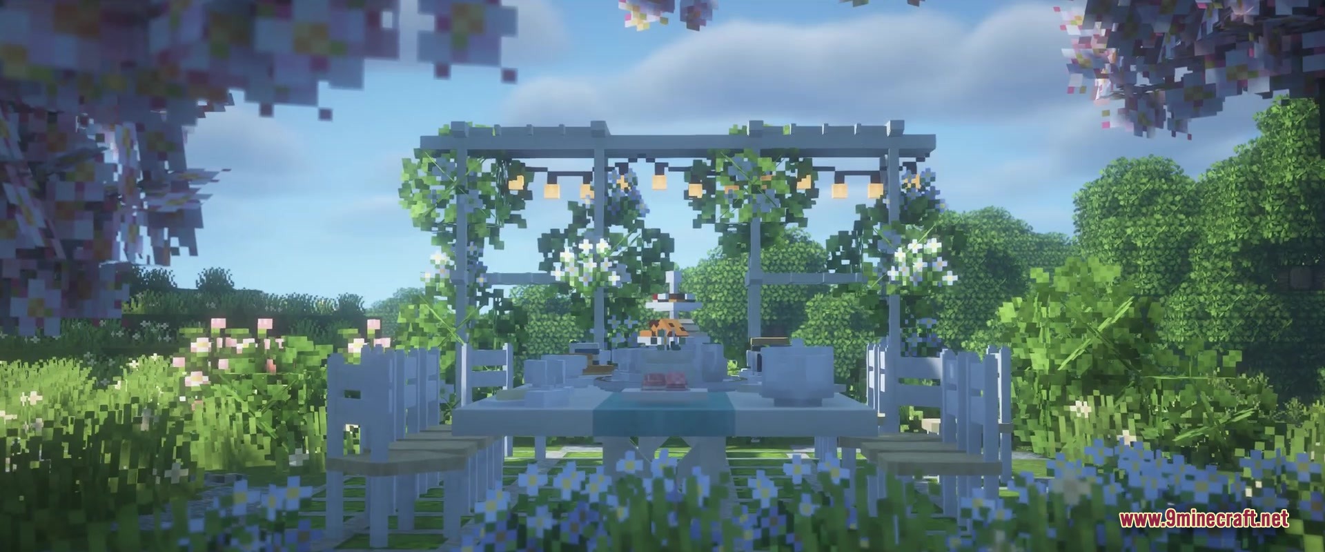 Outdoor dining area with white furniture and tea set under a decorated pergola
