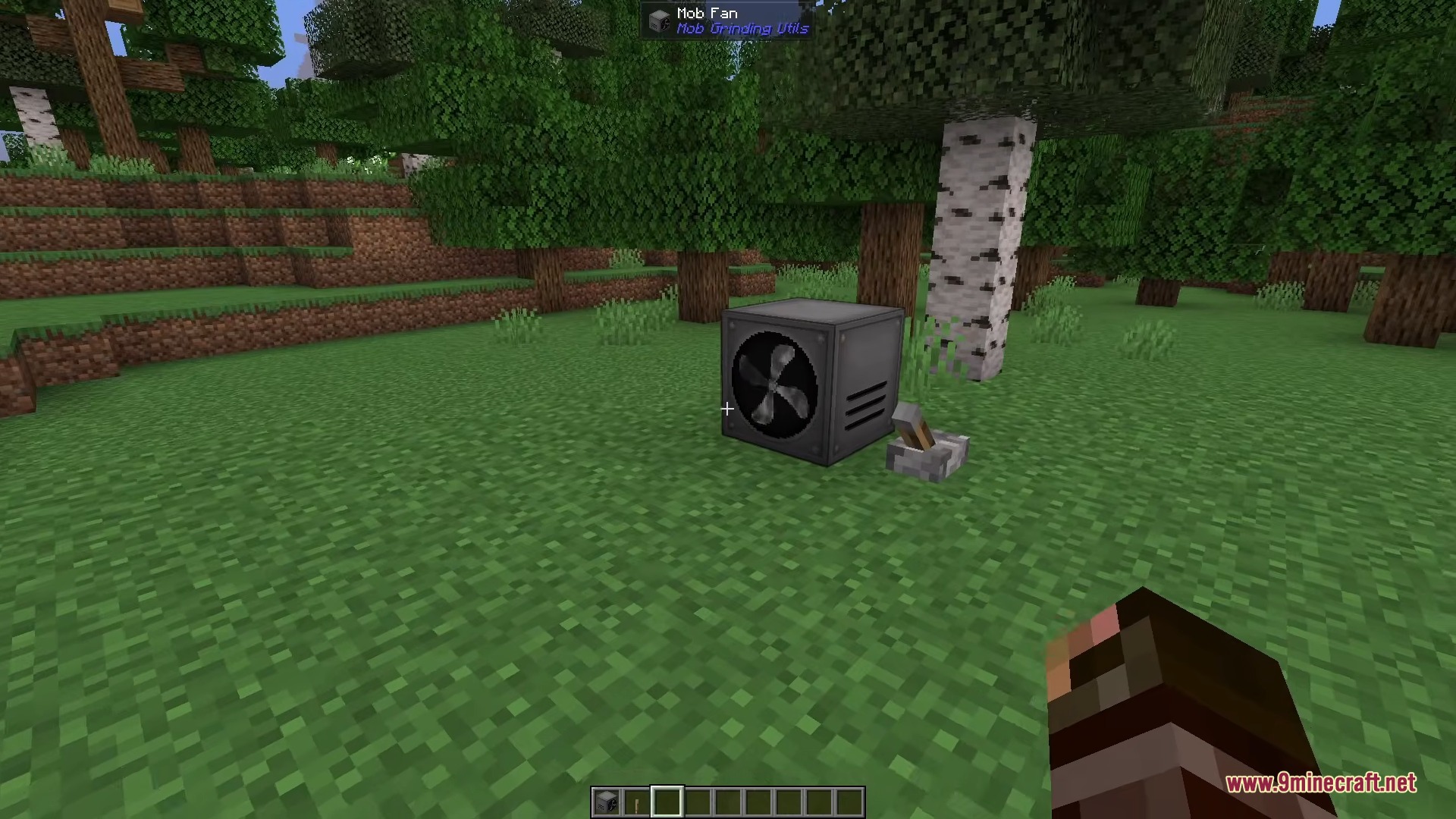 A Mob Fan block from Mob Grinding Utils placed on the grass
