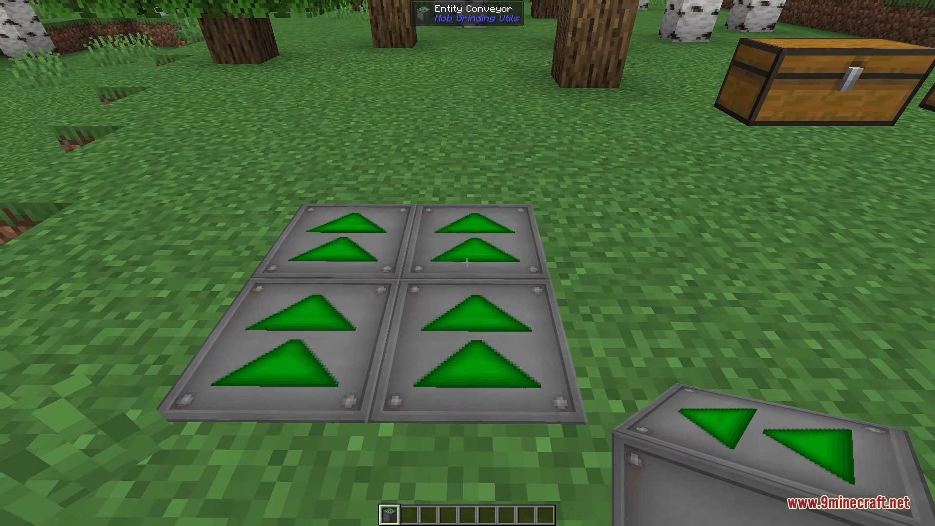 Four Entity Conveyor blocks with green arrows placed on the grass