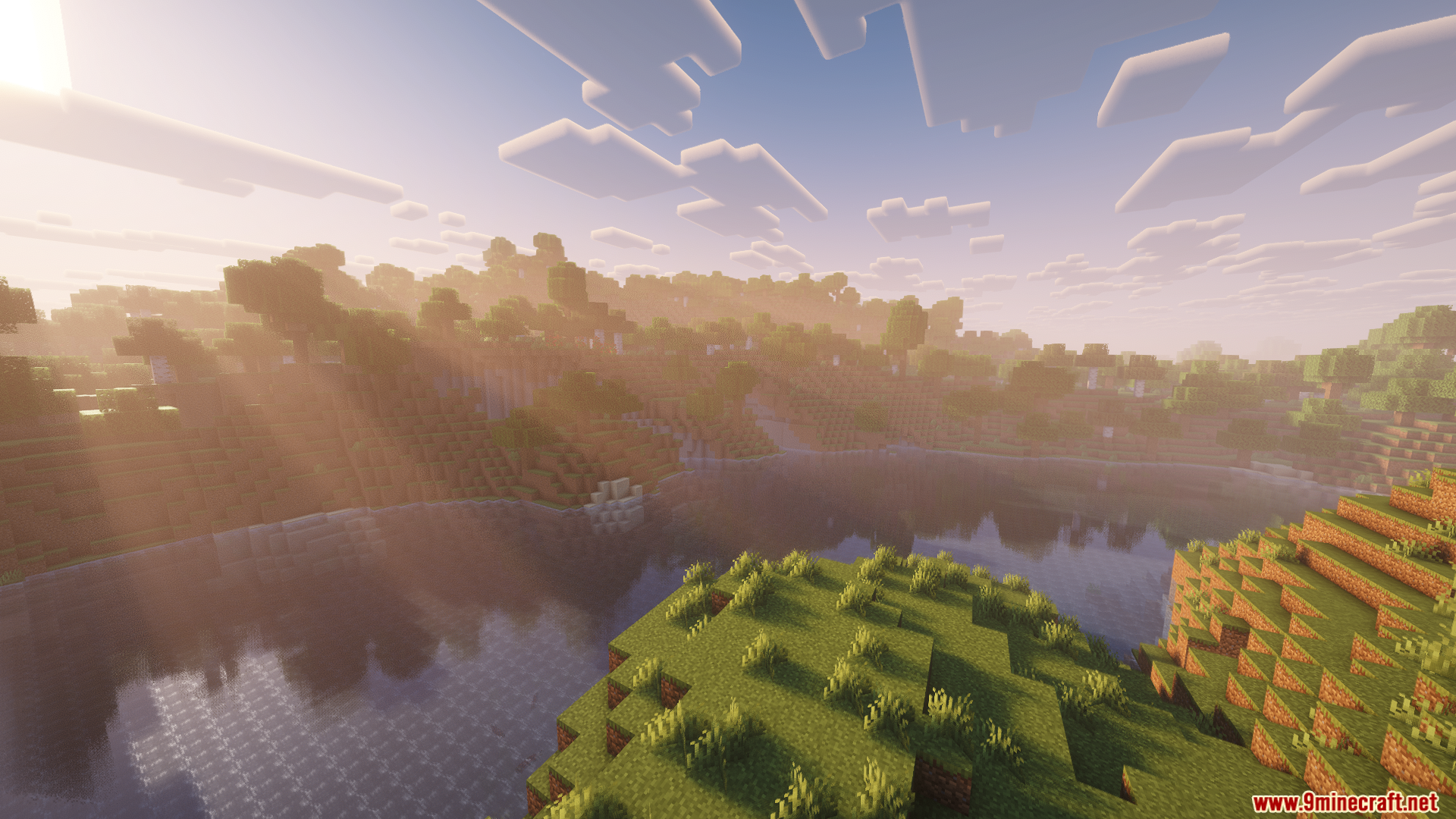 Monocle Mod Screenshot 4 Sun rays shining over a grassy hill and reflecting on a calm lake