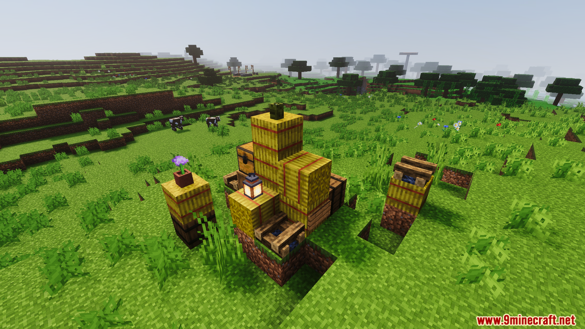 Moogs Voyager Structures Addon Screenshot 4 Decorative hay bales and a lantern in a grassy field with roaming cows