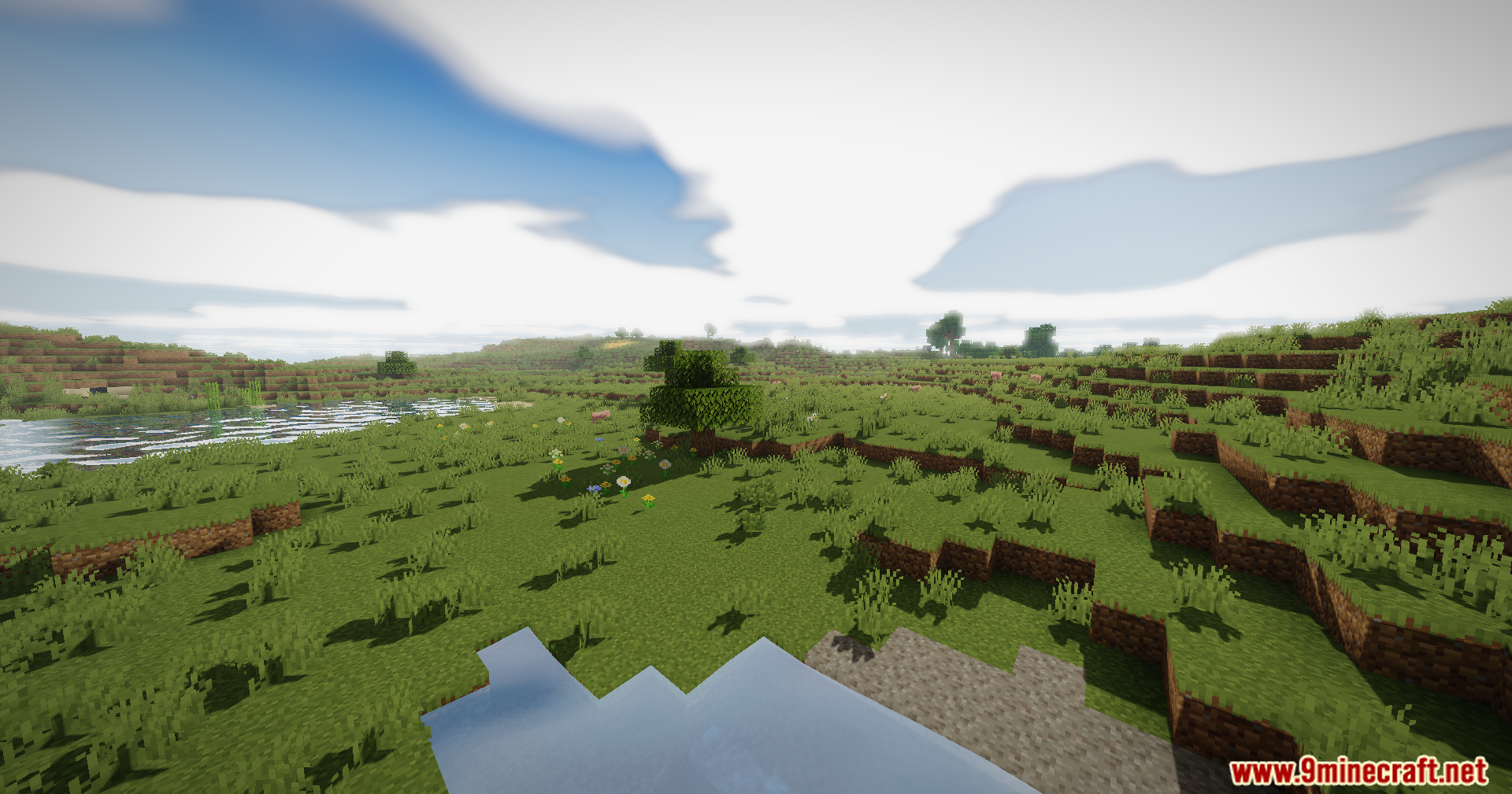 A wide Minecraft landscape featuring lush green plains and realistic water reflections