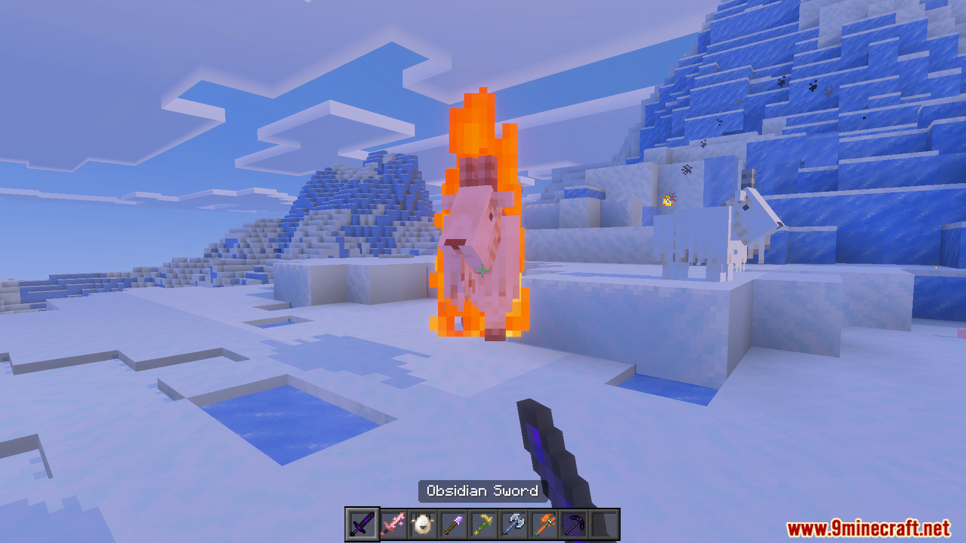 More Vanilla Tools Complete Addon Screenshot 10 Player holding an obsidian sword while a mob burns in a snowy biome