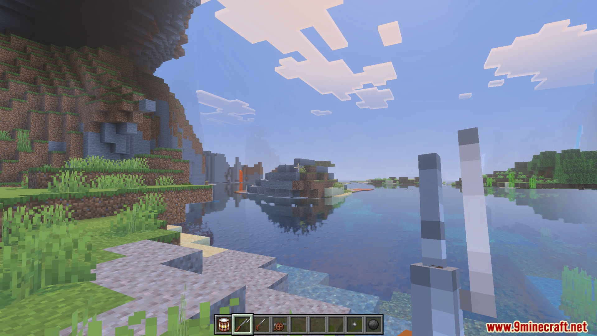 First person view of a player holding a weapon while overlooking the ocean