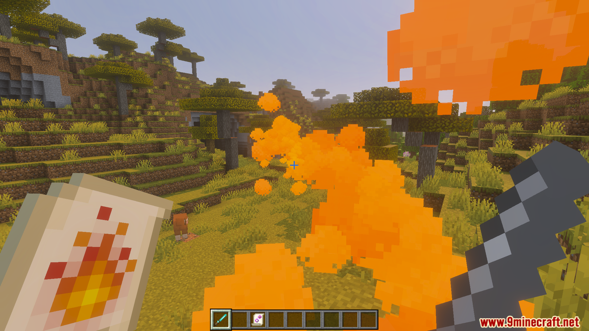 Nicos Magic Spells Addon Screenshot 4 Casting a fire spell with orange particles in a savanna biome landscape