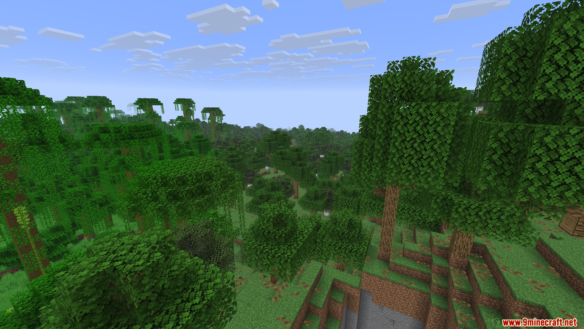 Optimized Fullbright Mod Screenshot 12 A wide view of a lush green jungle forest under a blue sky