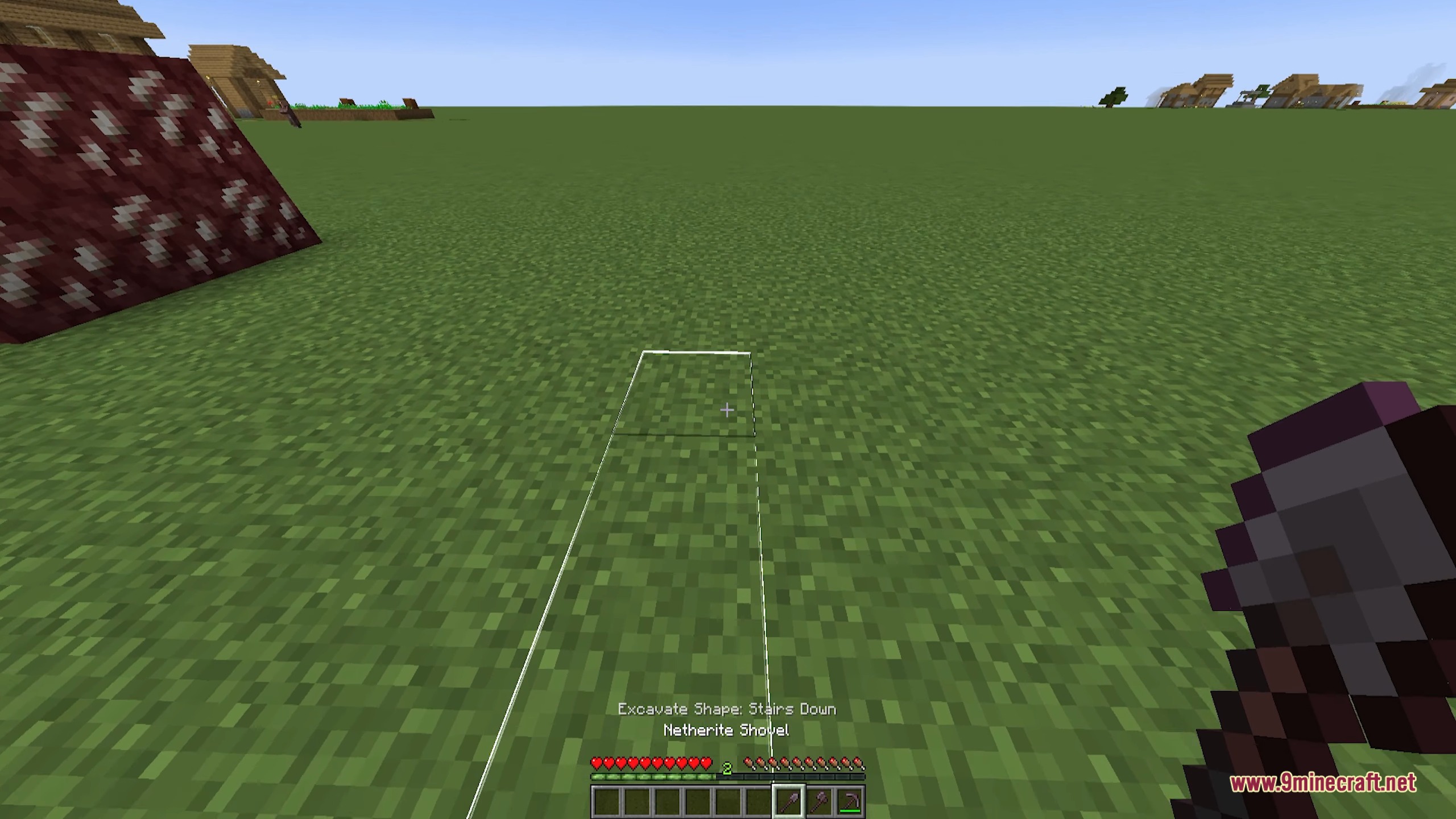 Player views a wireframe outline for digging stairs with a netherite shovel