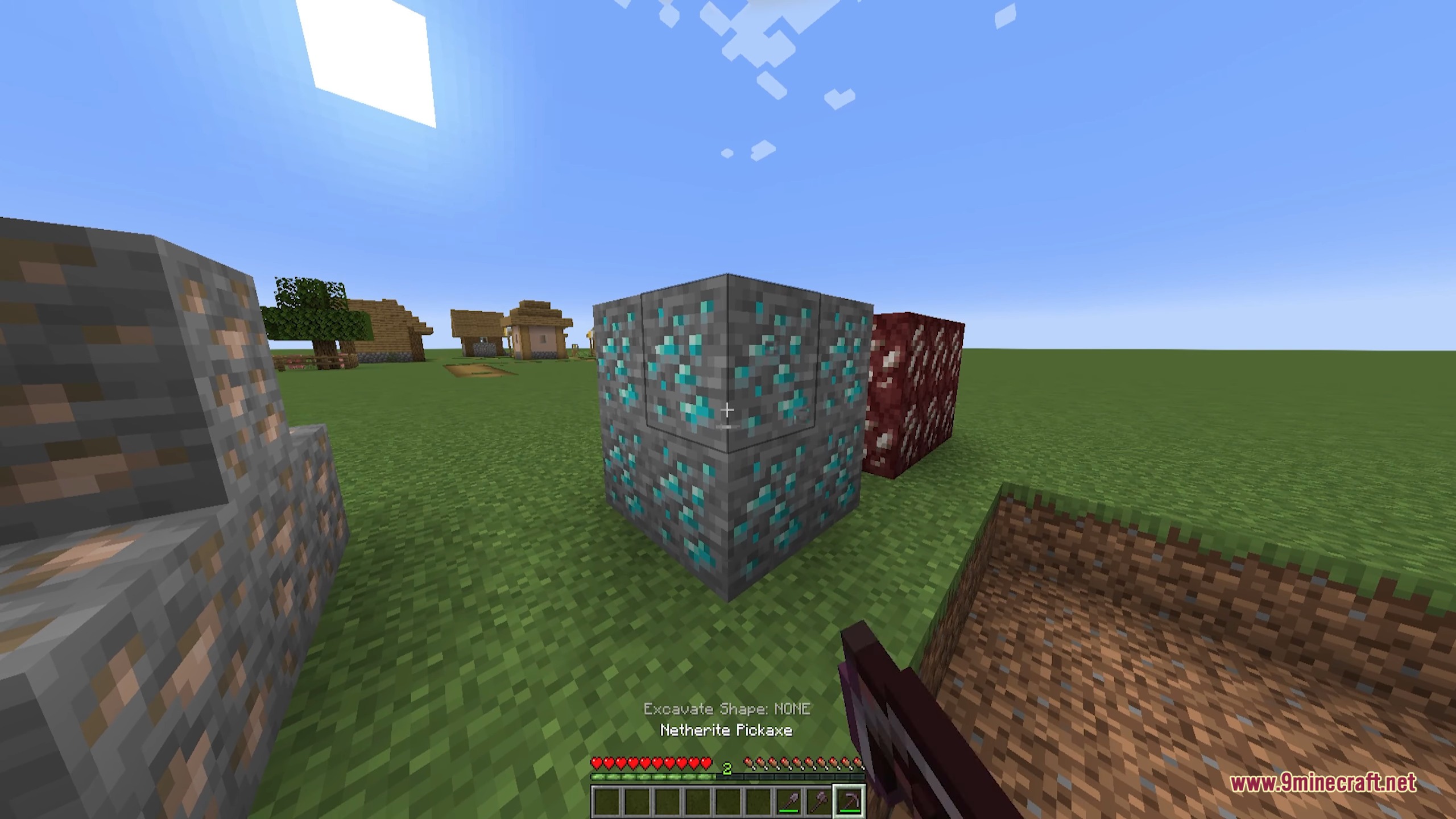 A player aims a Netherite Pickaxe at a large block of diamond ore