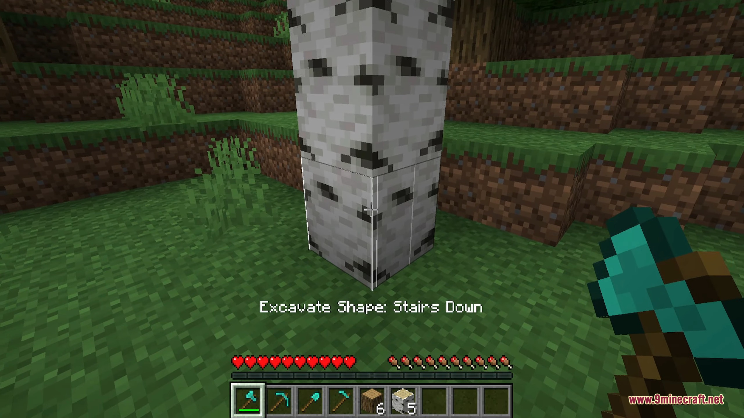 A player uses a diamond axe to select the stairs down excavation shape