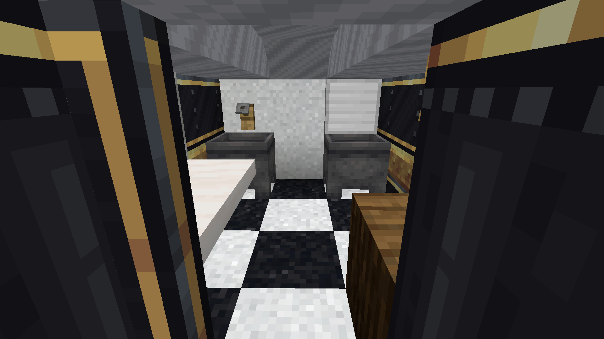 A small train kitchen featuring cauldrons for sinks and black and white floors