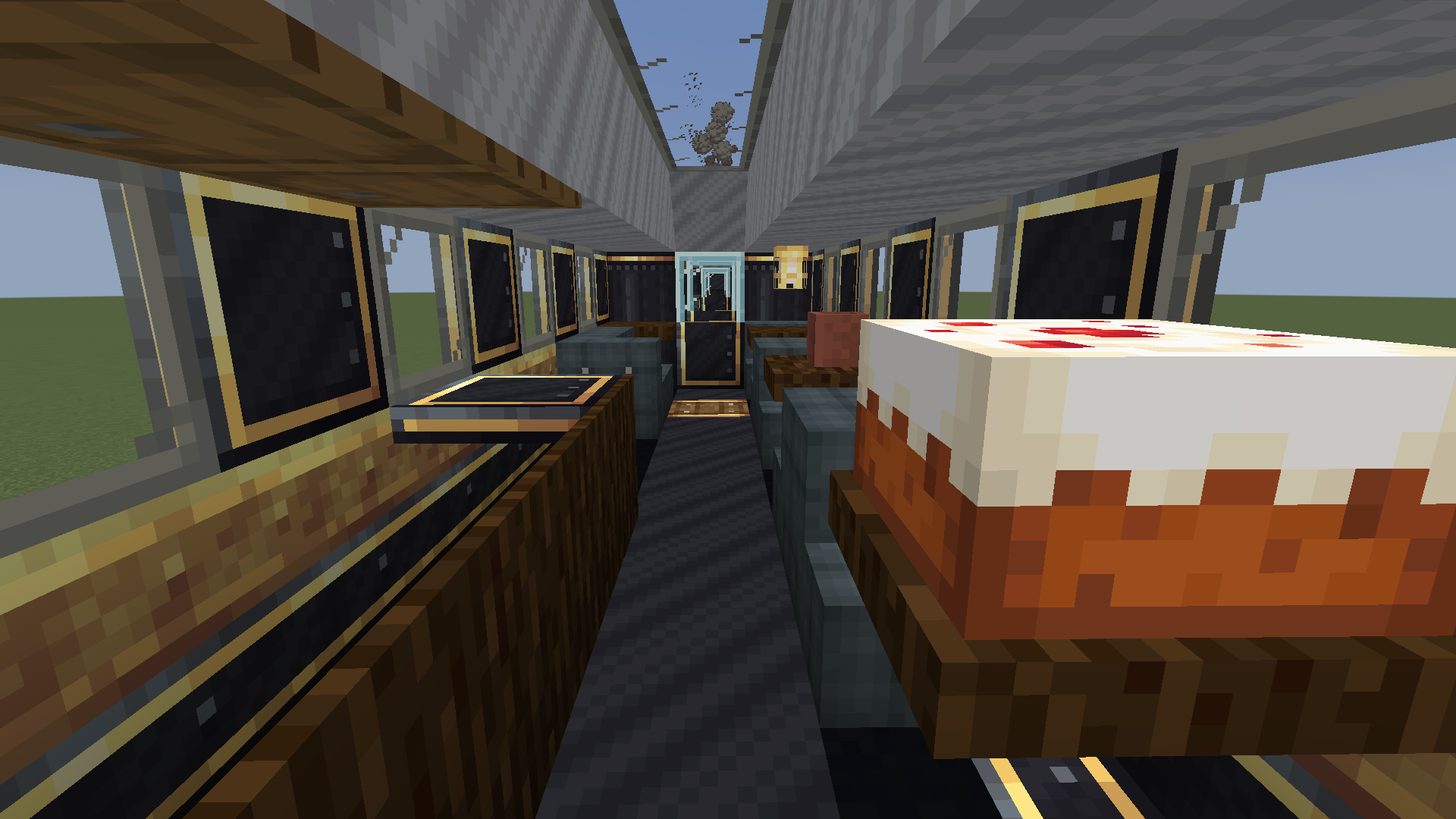 Interior of a train dining car with a cake and wooden counters