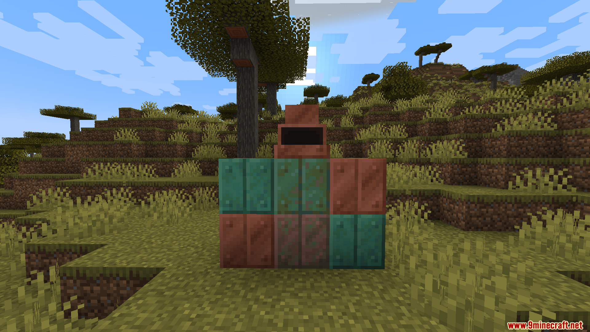 A collection of copper blocks and a furnace placed in the savanna