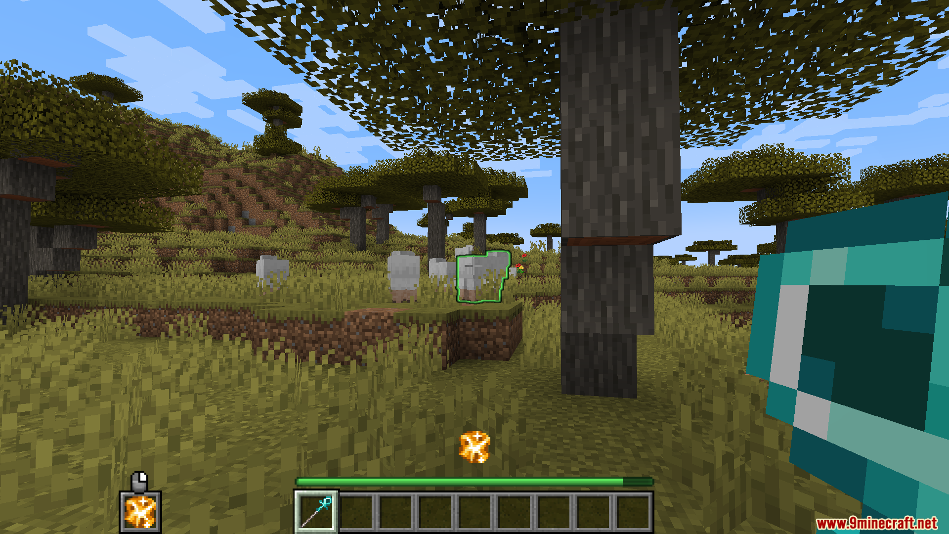 A player uses a magical staff to target a sheep in Minecraft