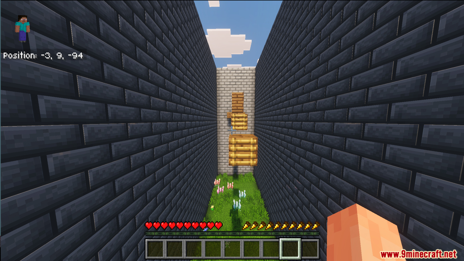 First person view of floating wooden blocks in a narrow stone brick hallway