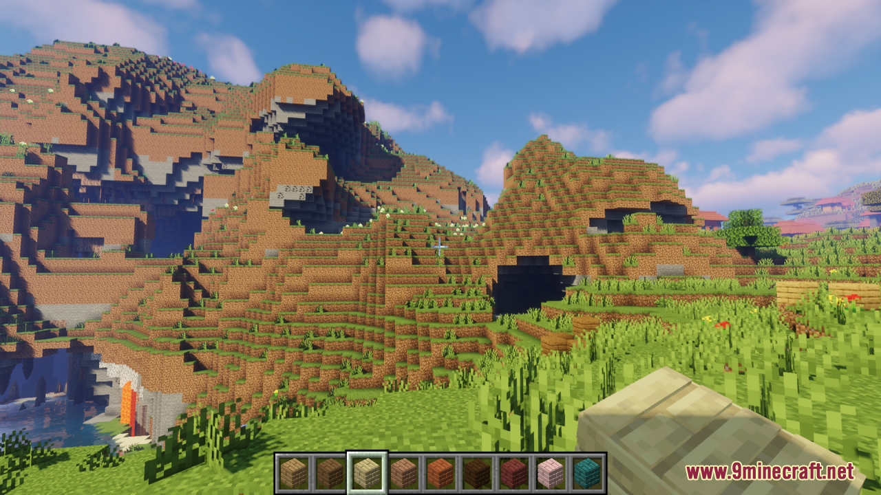 A scenic mountain landscape with various 3D wooden planks in the hotbar