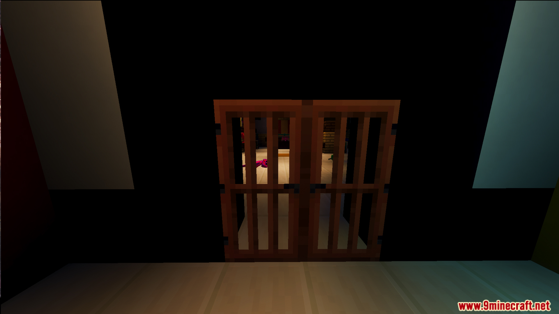 Looking through a wooden barred door into a dark room with toys