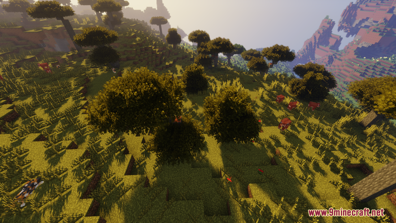 Rainbow's Foliage Resource Pack Screenshot 10 Red cows grazing near bushy trees in a sunny savanna biome