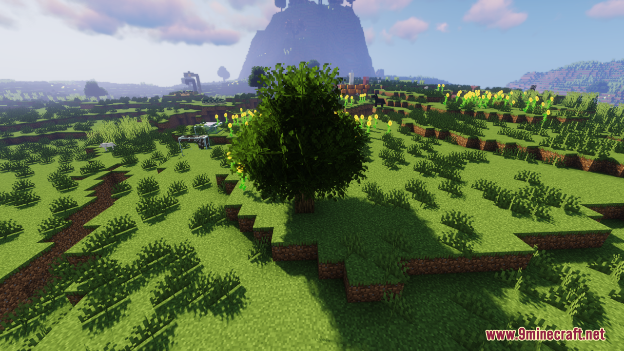 Rainbow's Foliage Resource Pack Screenshot 13 A bushy tree stands in a grassy field with yellow flowers and mountains