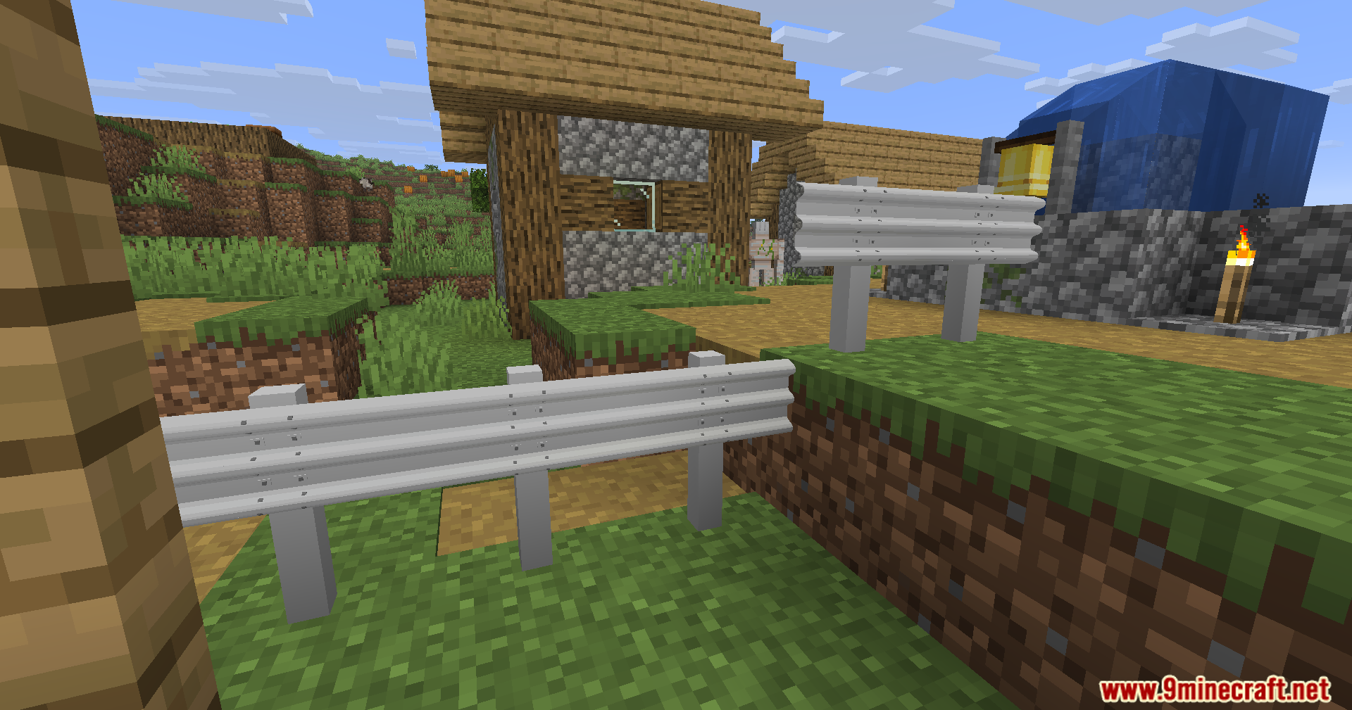 Modern metal guardrails from Reality City Construction Mod placed in a village