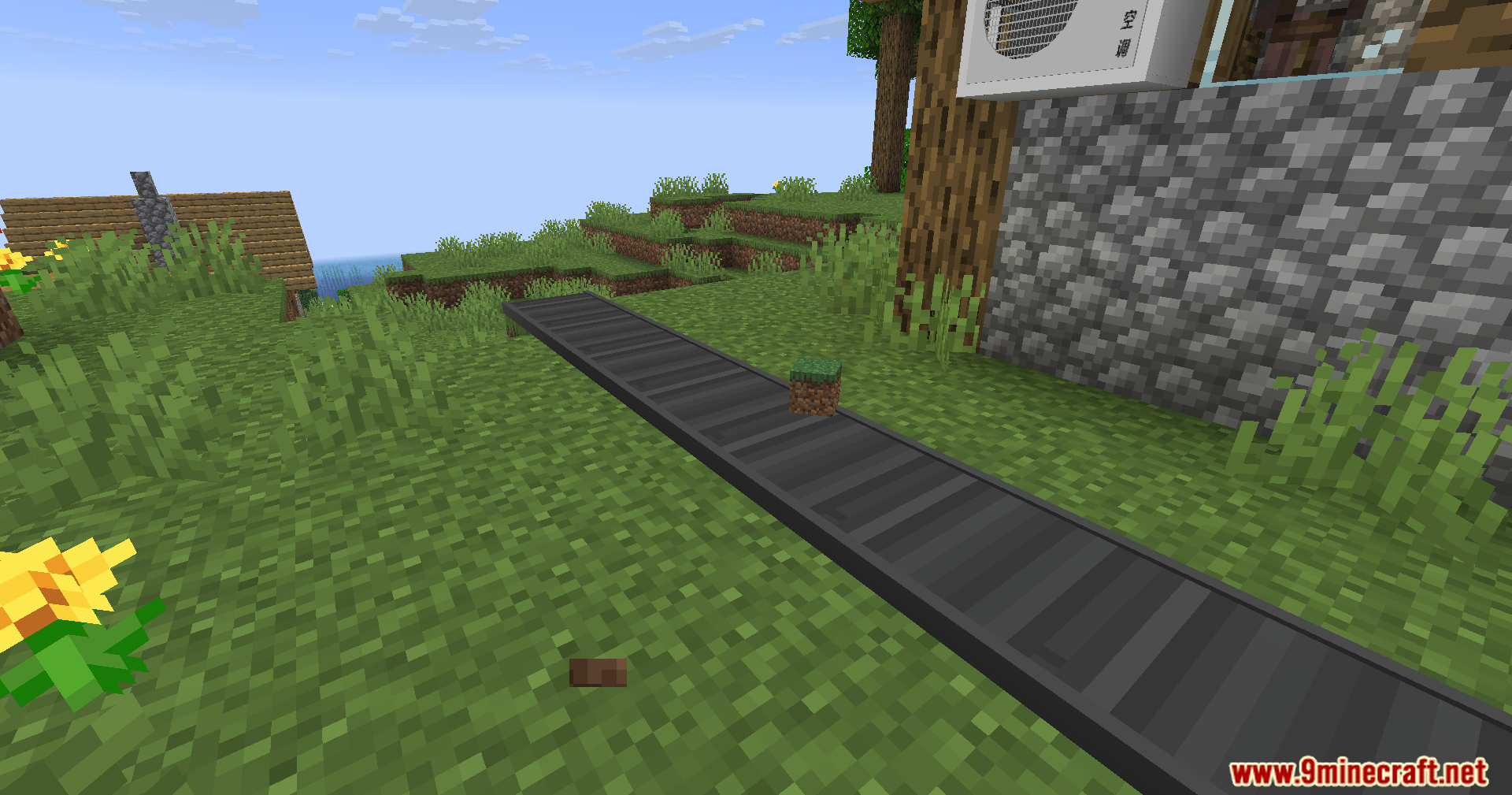 A grass block item moves along a conveyor belt in a village