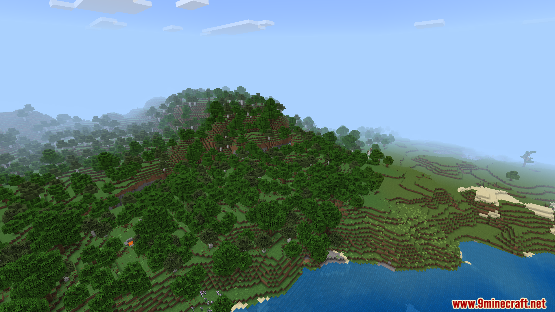 Rebuilt Shader Screenshot 8 A dense forest covering a hillside overlooking a vast blue ocean in Minecraft