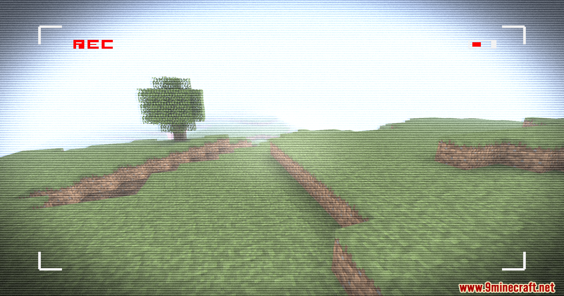 Retro VHS Screen Shaders Screenshot 1 Lone tree on a grassy hill viewed through a retro VHS filter