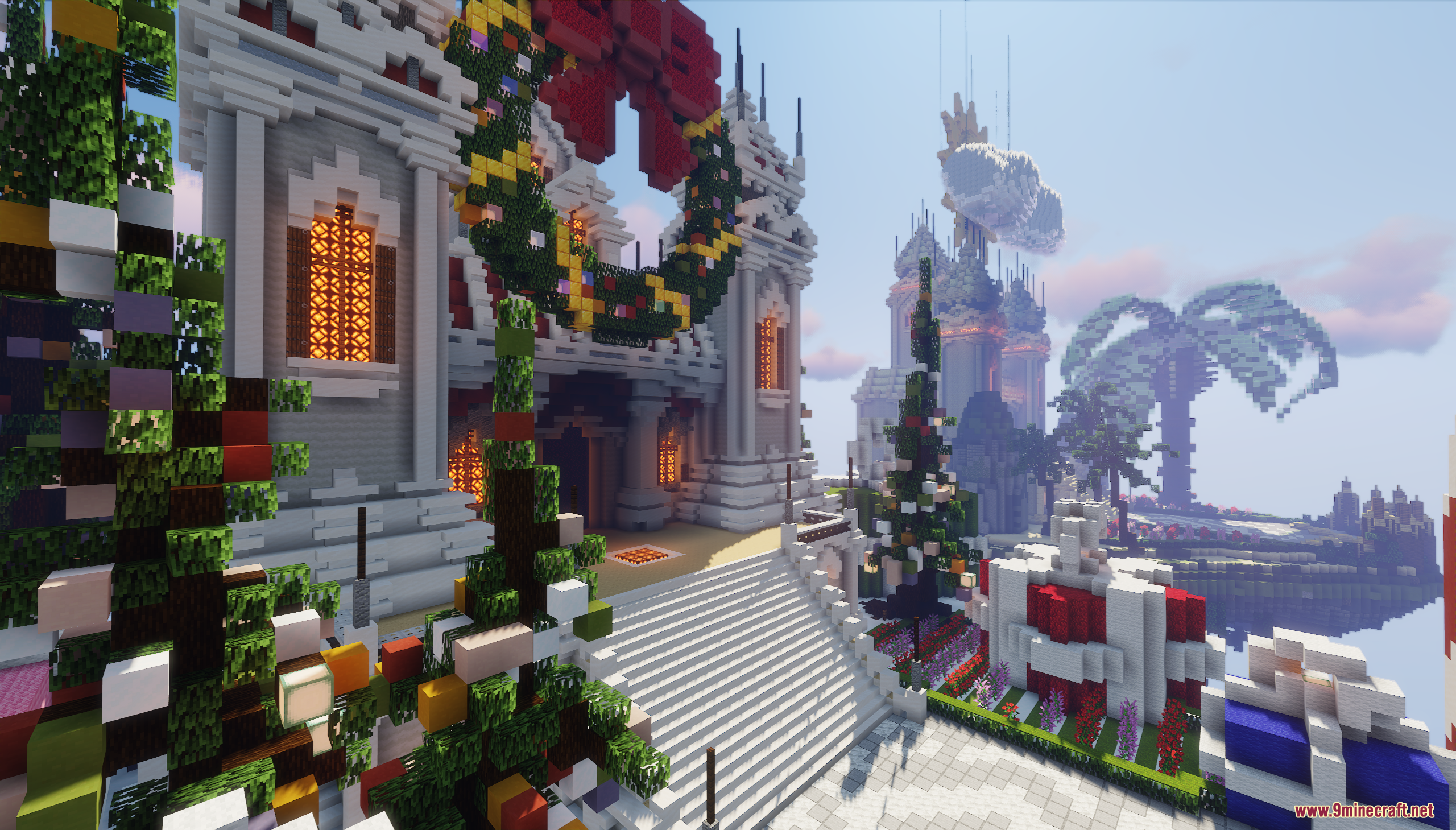 A festive lobby decorated with a giant wreath and colorful Christmas trees