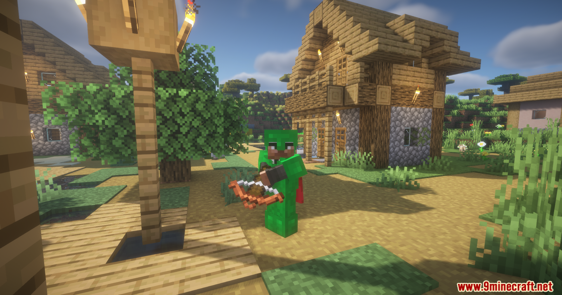 Silent Gear Metalworks Mod Screenshot 12 A player in green armor holds a crossbow in a village setting