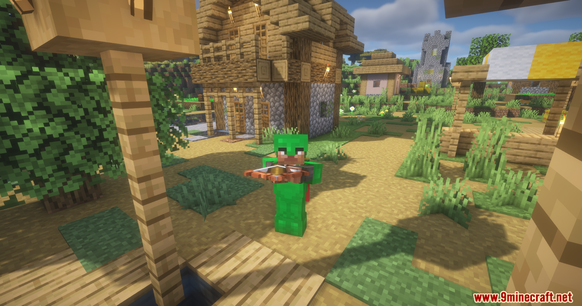 Silent Gear Metalworks Mod Screenshot 13 A player wearing green armor holds a crossbow in a sunny village