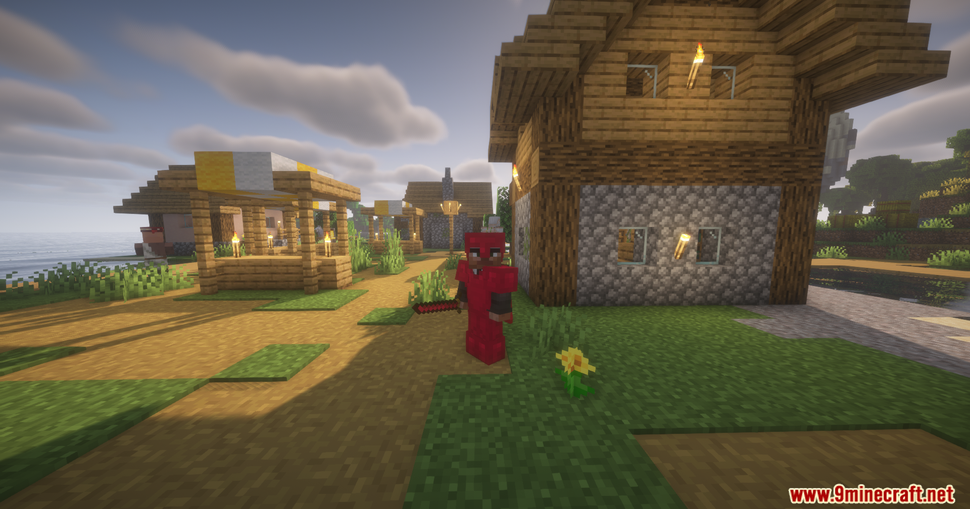 Silent Gear Metalworks Mod Screenshot 7 A player wearing red metal armor and holding a red sword in village