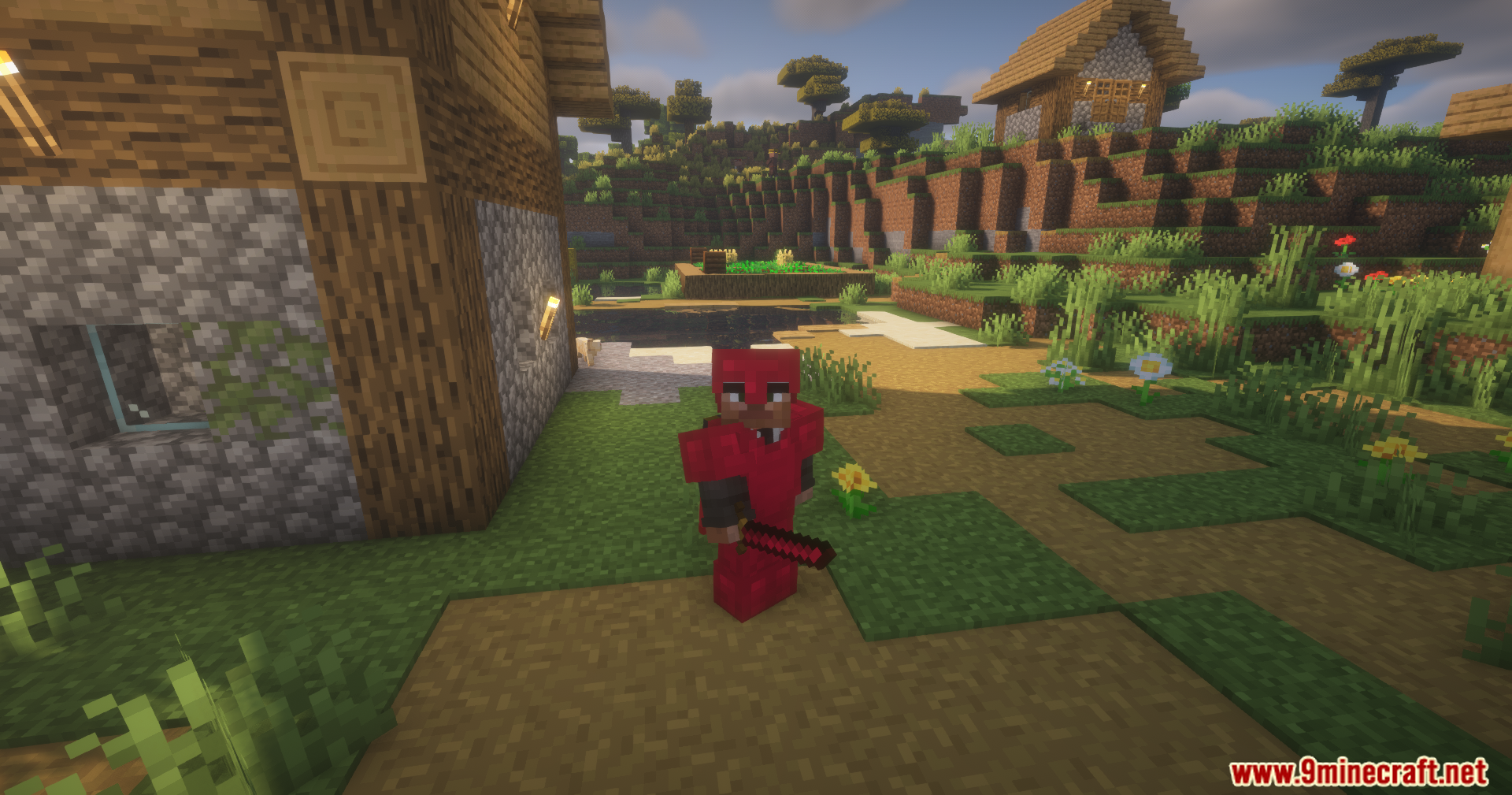 Silent Gear Metalworks Mod Screenshot 8 Minecraft character in red metal gear standing near a wooden village house