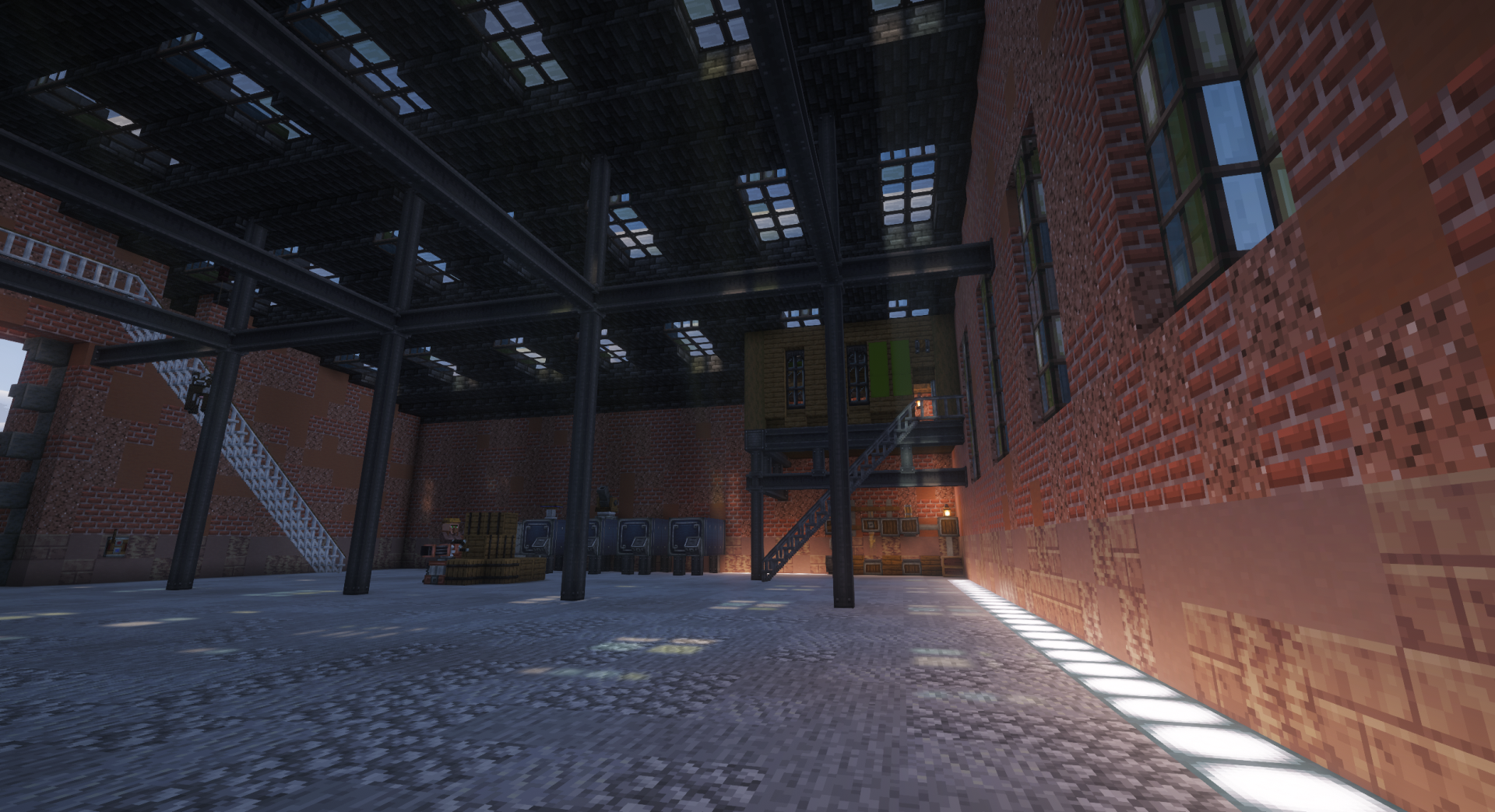Spacious interior of a large brick hangar with skylights and steel beams