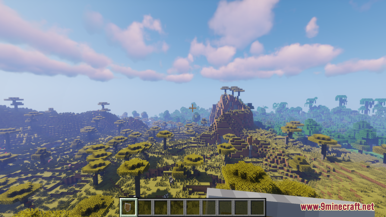 Simple Kite Shield Resource Pack Screenshot 2 A player holds a kite shield while looking at a vast savanna biome