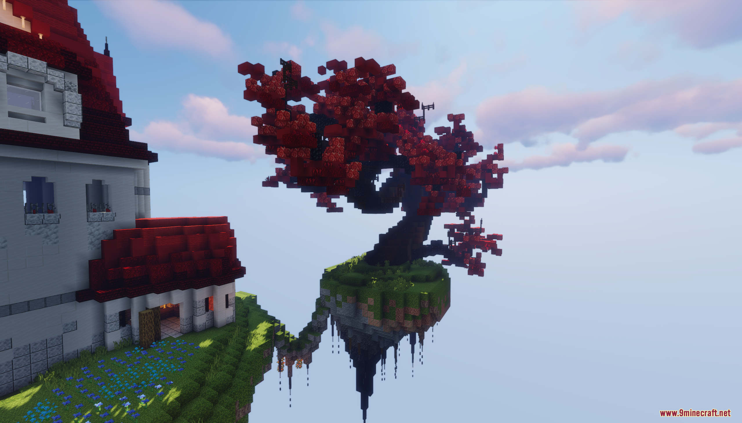 A large red tree grows on a floating island next to a white house
