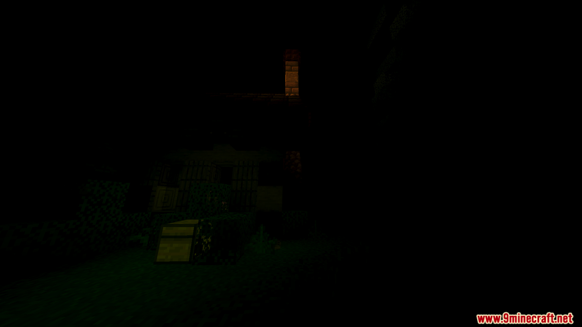 A small wooden building illuminated by a faint light in the dark woods