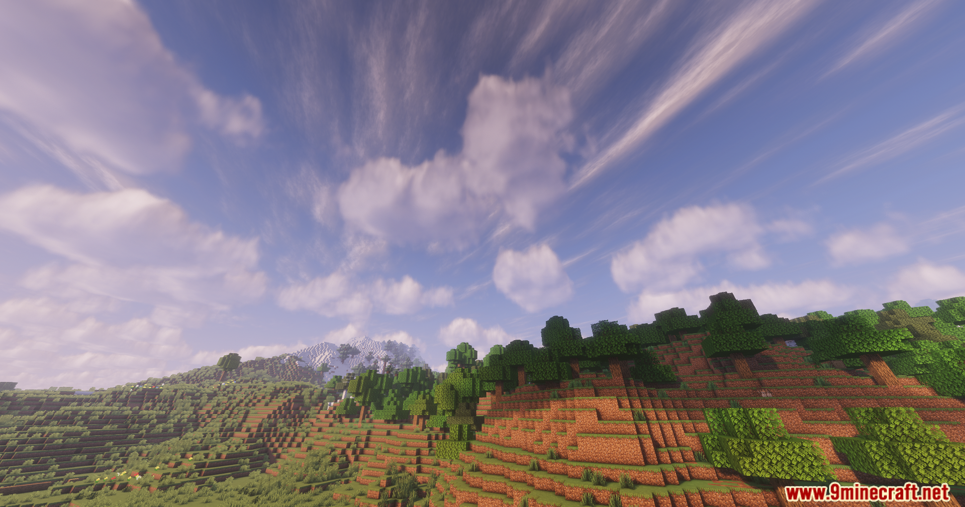 Solar Shaders Screenshot 2 Lush green forest and mountains under a vibrant sky with wispy clouds