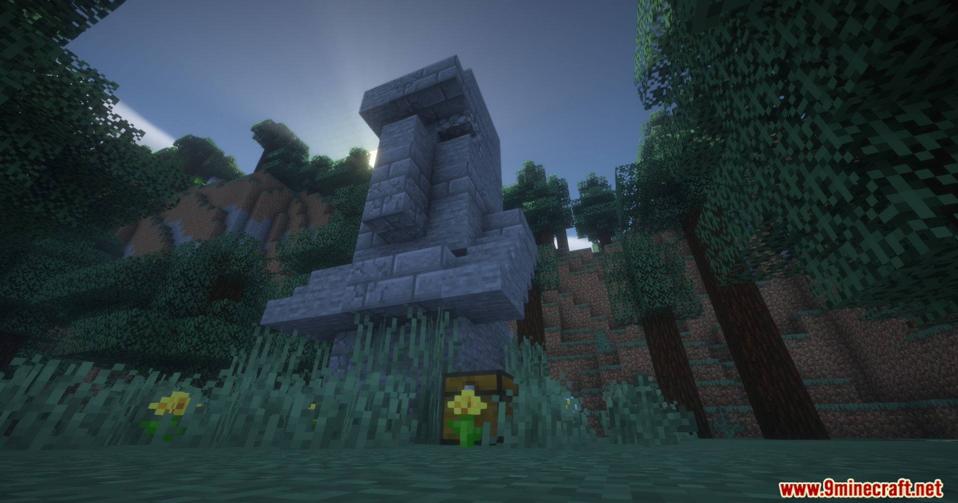 A giant stone head statue with a chest at its base