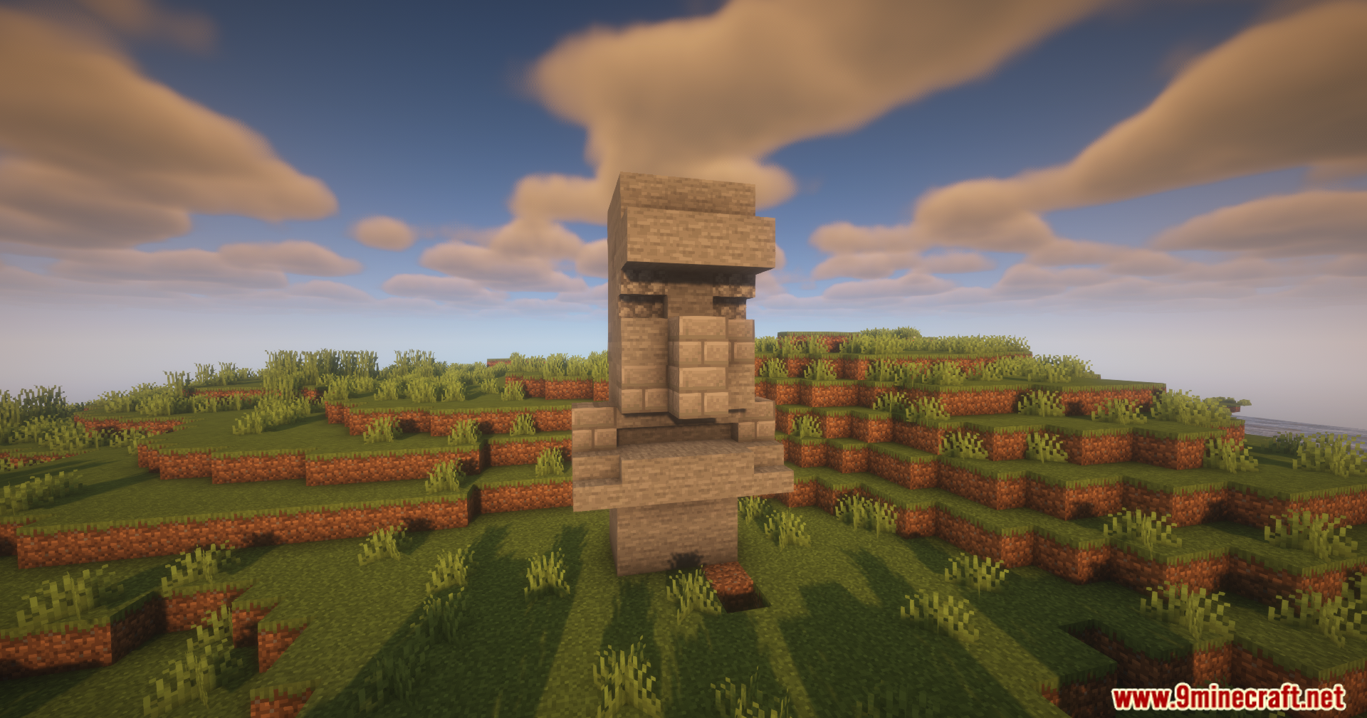 Front view of a stone villager statue in a grassy Minecraft landscape