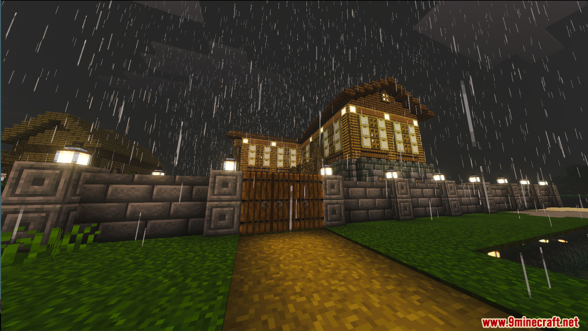 A stone brick wall and wooden gate surround the traditional house in rain