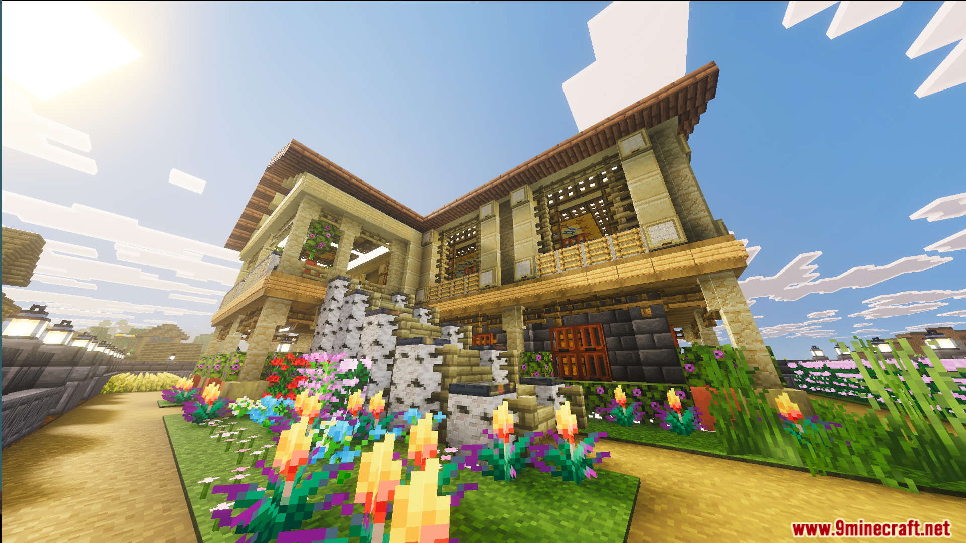 A side view of the mansion with colorful flowers and birch stairs