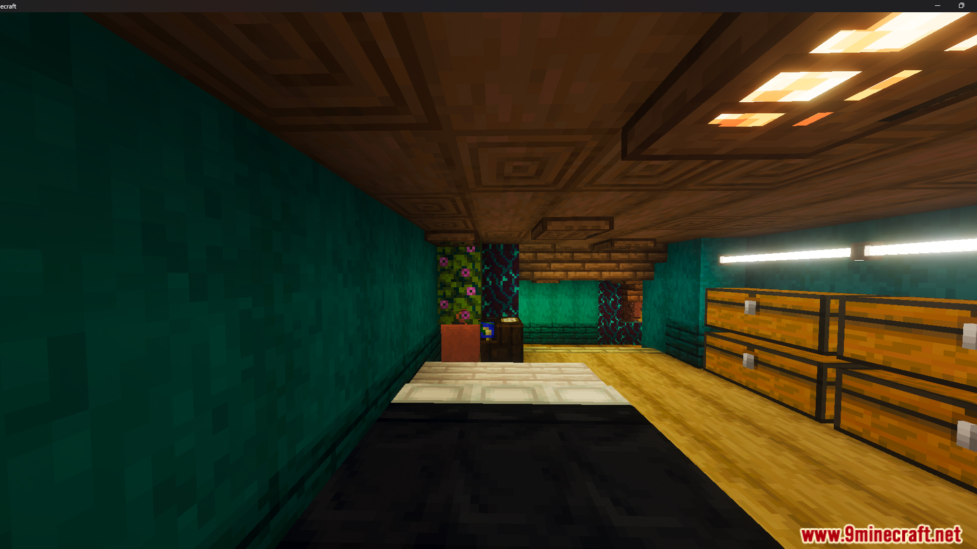 Interior of a bedroom with teal walls wooden chests and a low ceiling