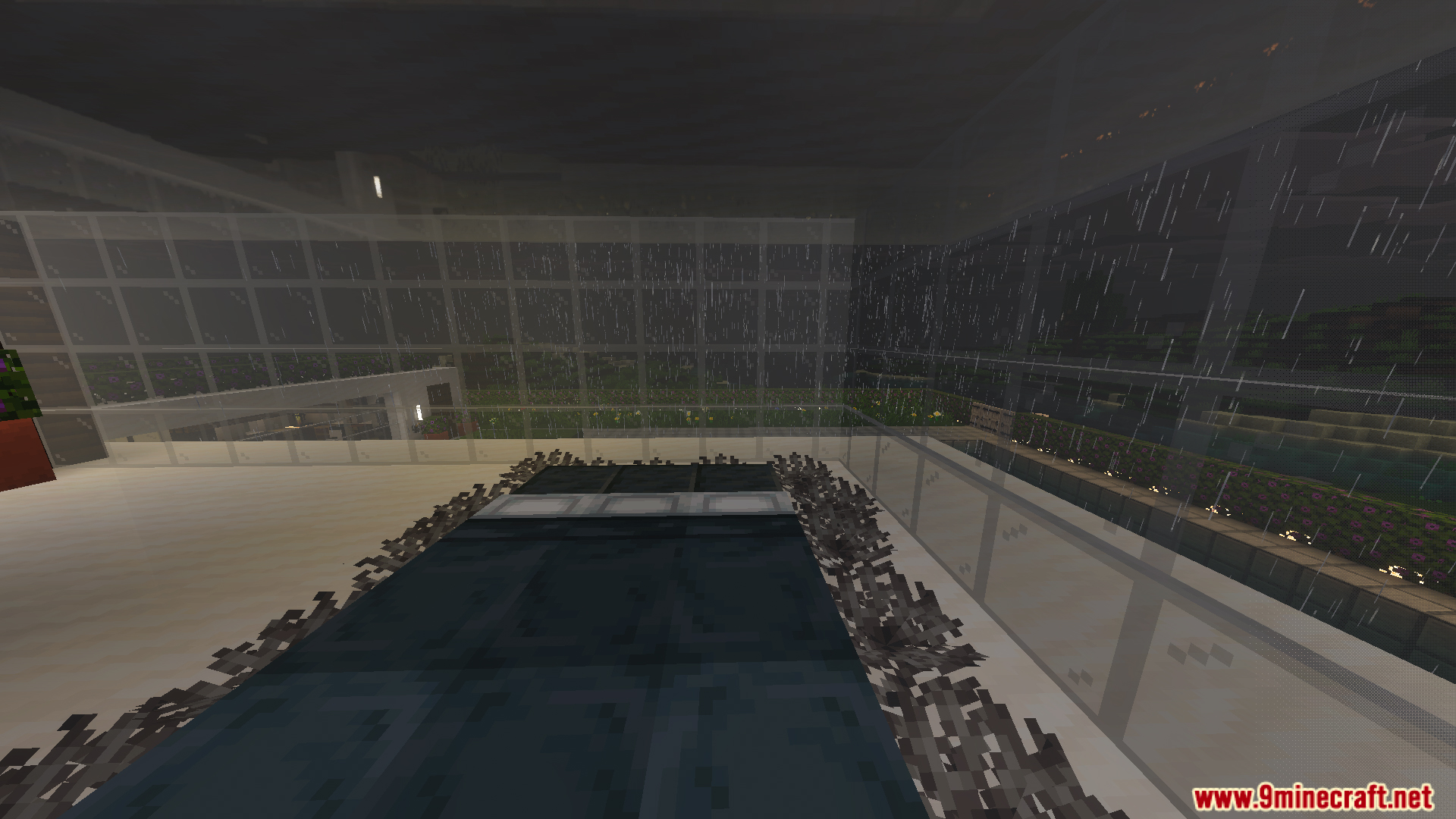 Modern interior room with dark flooring and glass walls during a rainy night