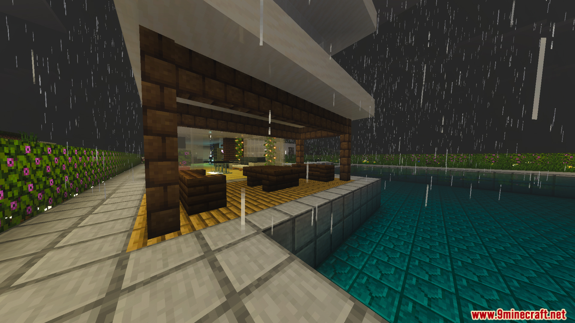 Modern outdoor seating area next to a swimming pool in the rain