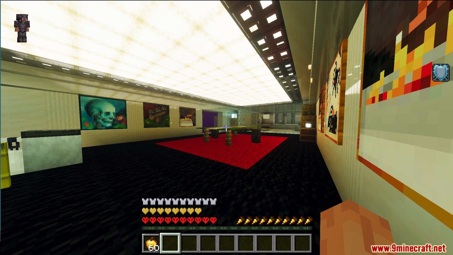 A fully decorated room with paintings and a large red carpet
