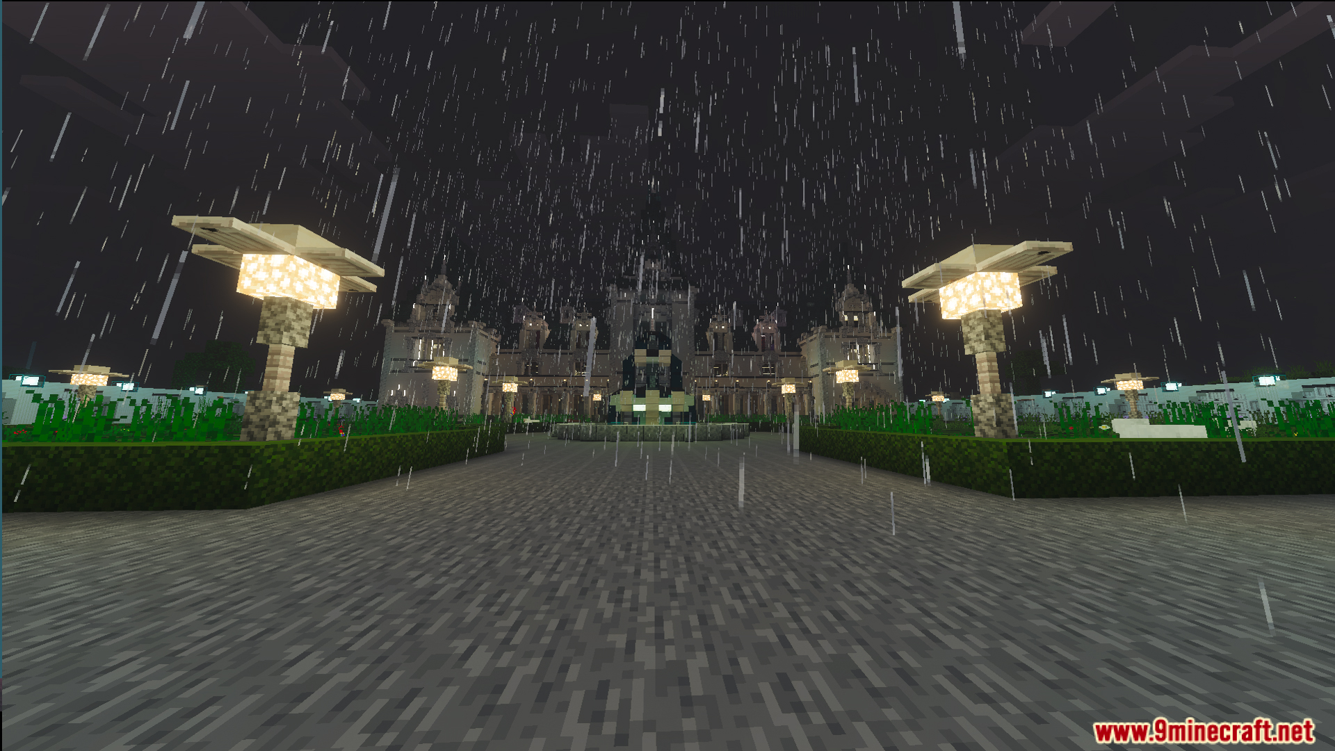 Rainy night view of the Survival Victorian Mansion garden and fountain