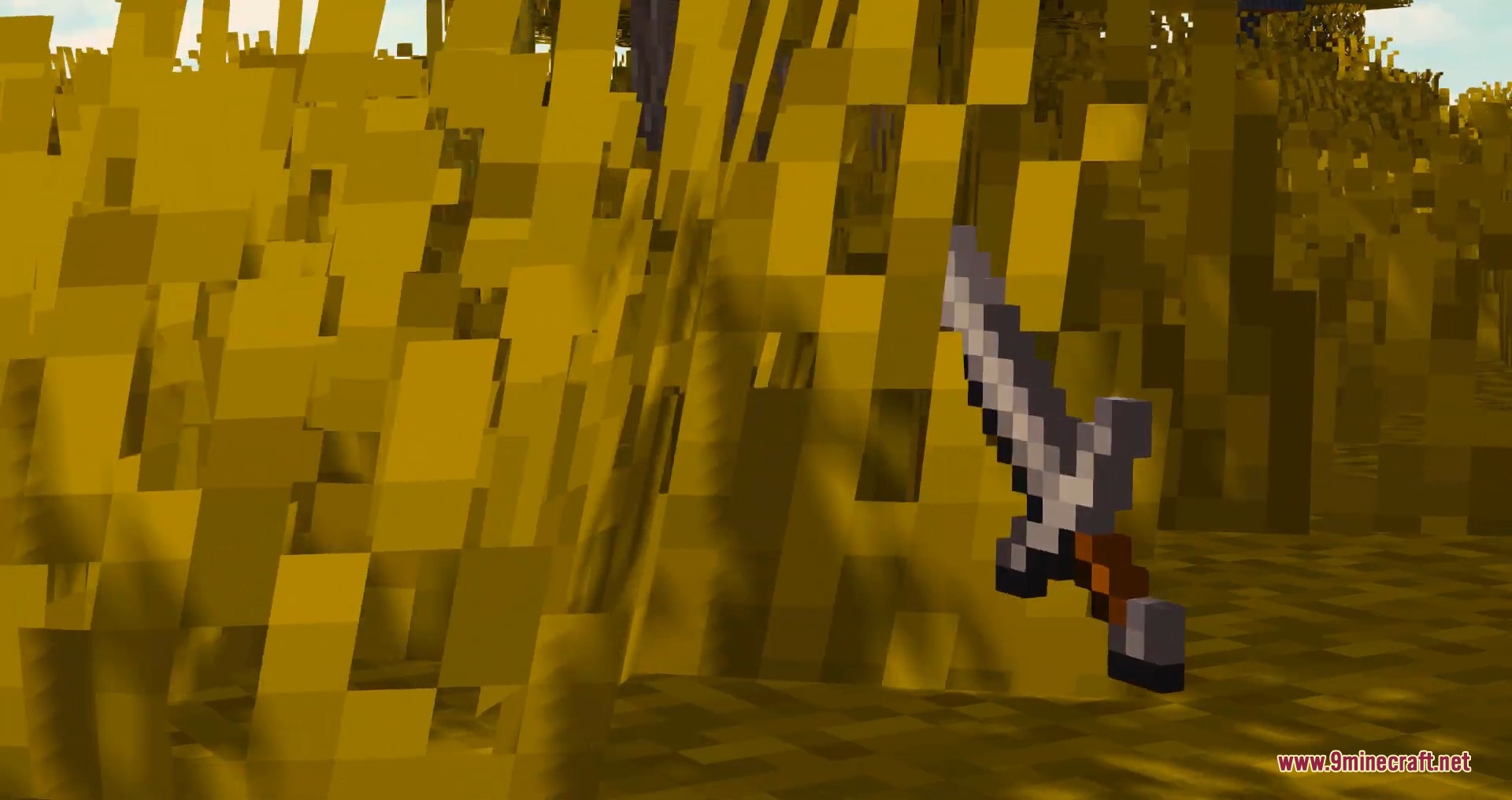 A stone sword is placed upright in a field of tall yellow grass