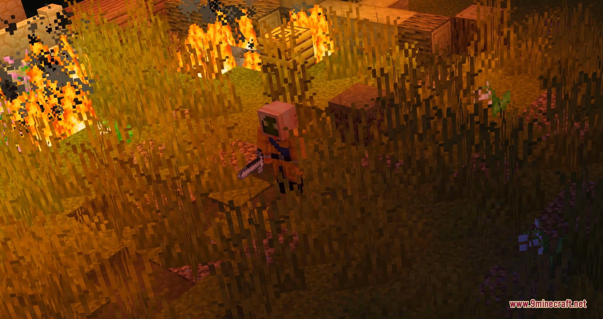 A baby zombie stands in tall grass near a fire in Minecraft